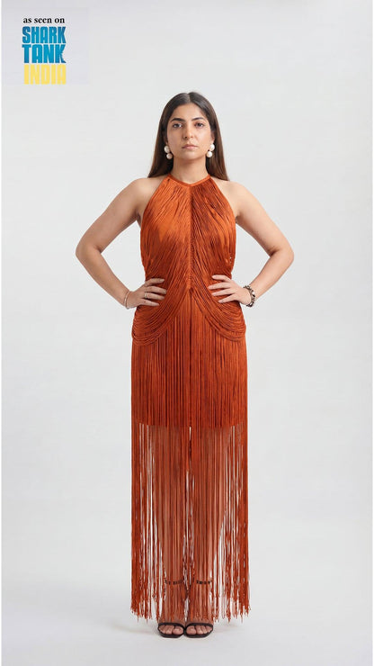 Woman wearing a rust-colored fringe dress on a white background with 'Shark Tank' branding.