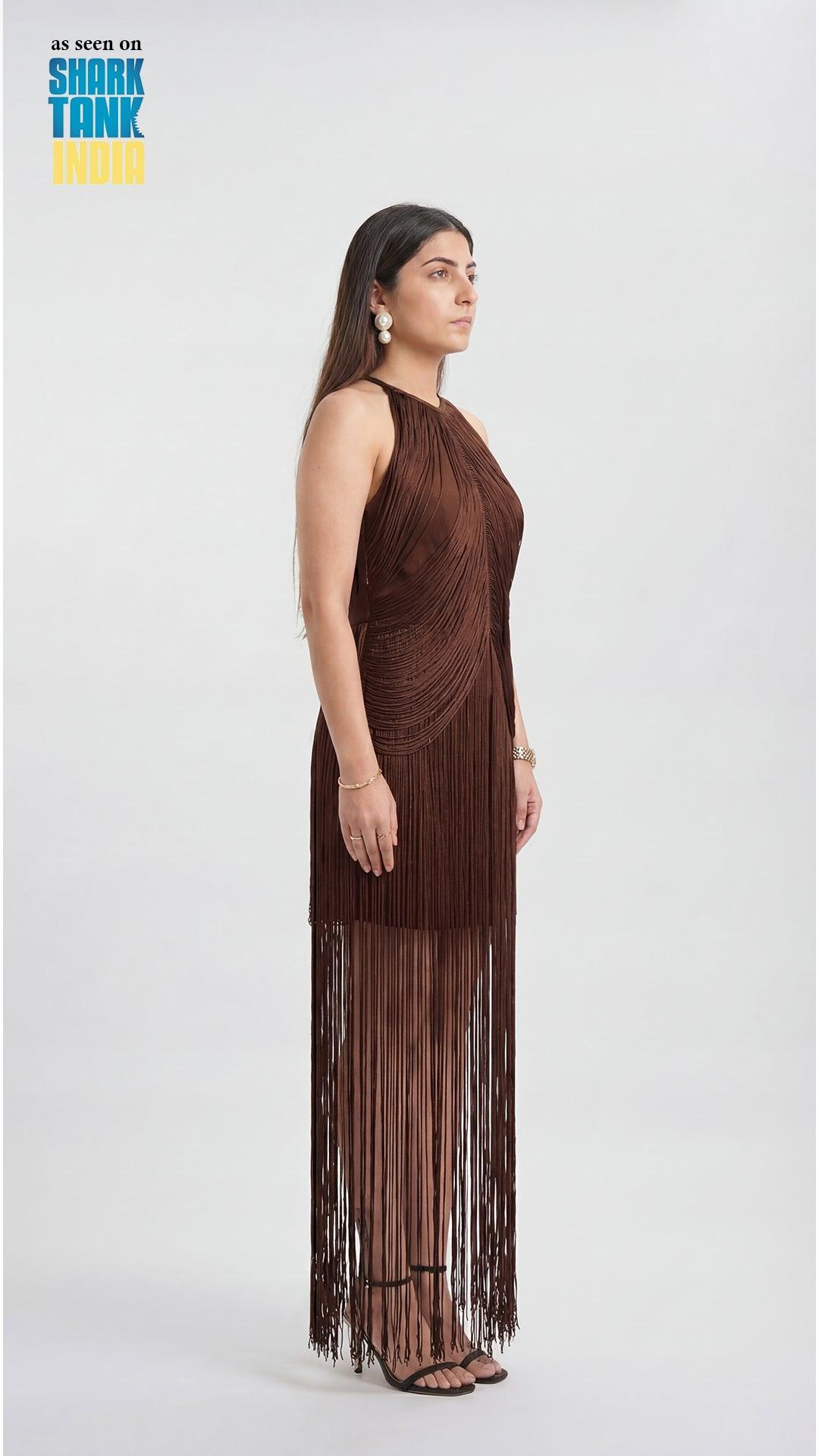 Woman wearing a brown fringe dress on a white background with 'Shark Tank' branding.