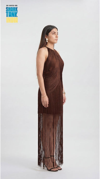 Woman wearing a brown fringe dress on a white background with 'Shark Tank' branding.