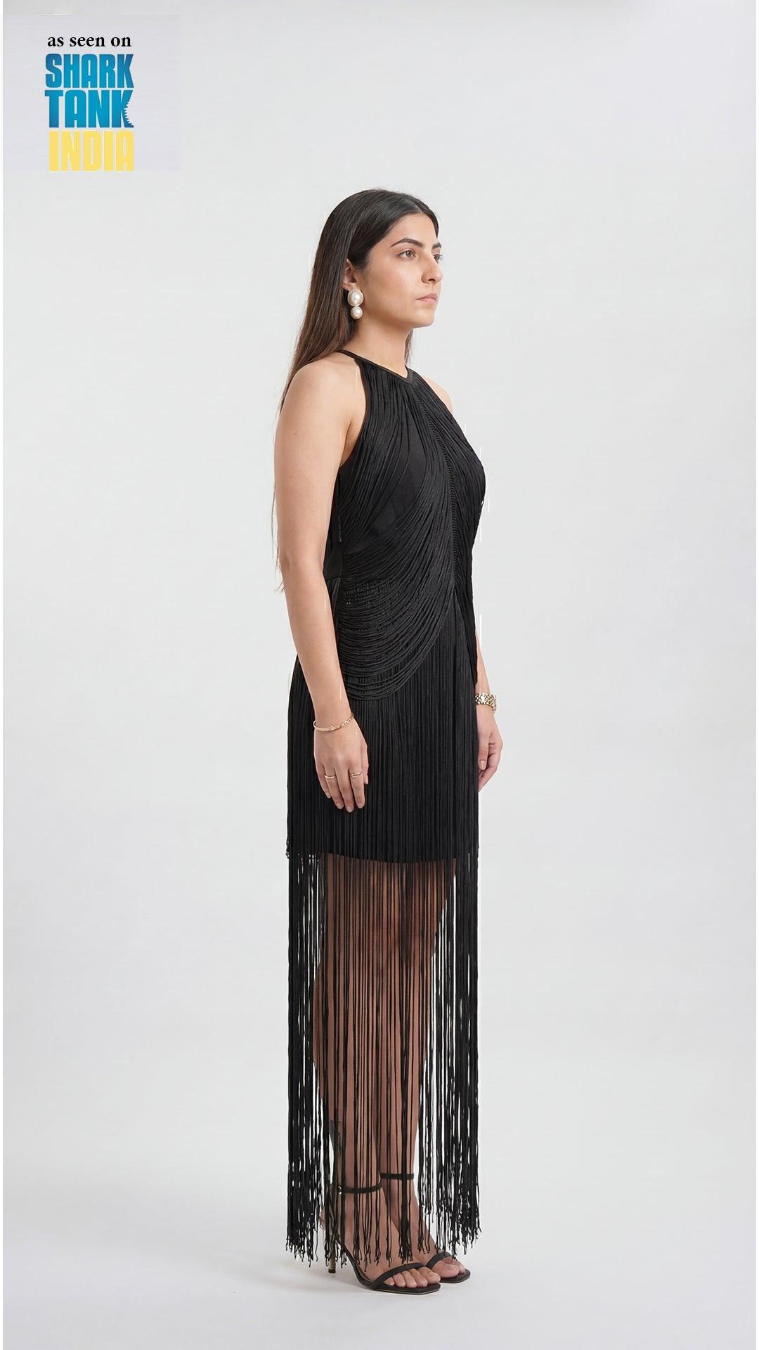 Woman wearing a black fringe dress on a white background with 'Shark Tank' branding.