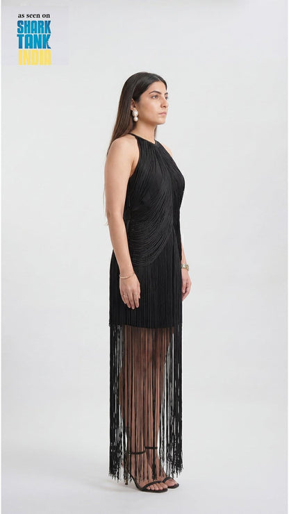Woman wearing a black fringe dress on a white background with 'Shark Tank' branding.