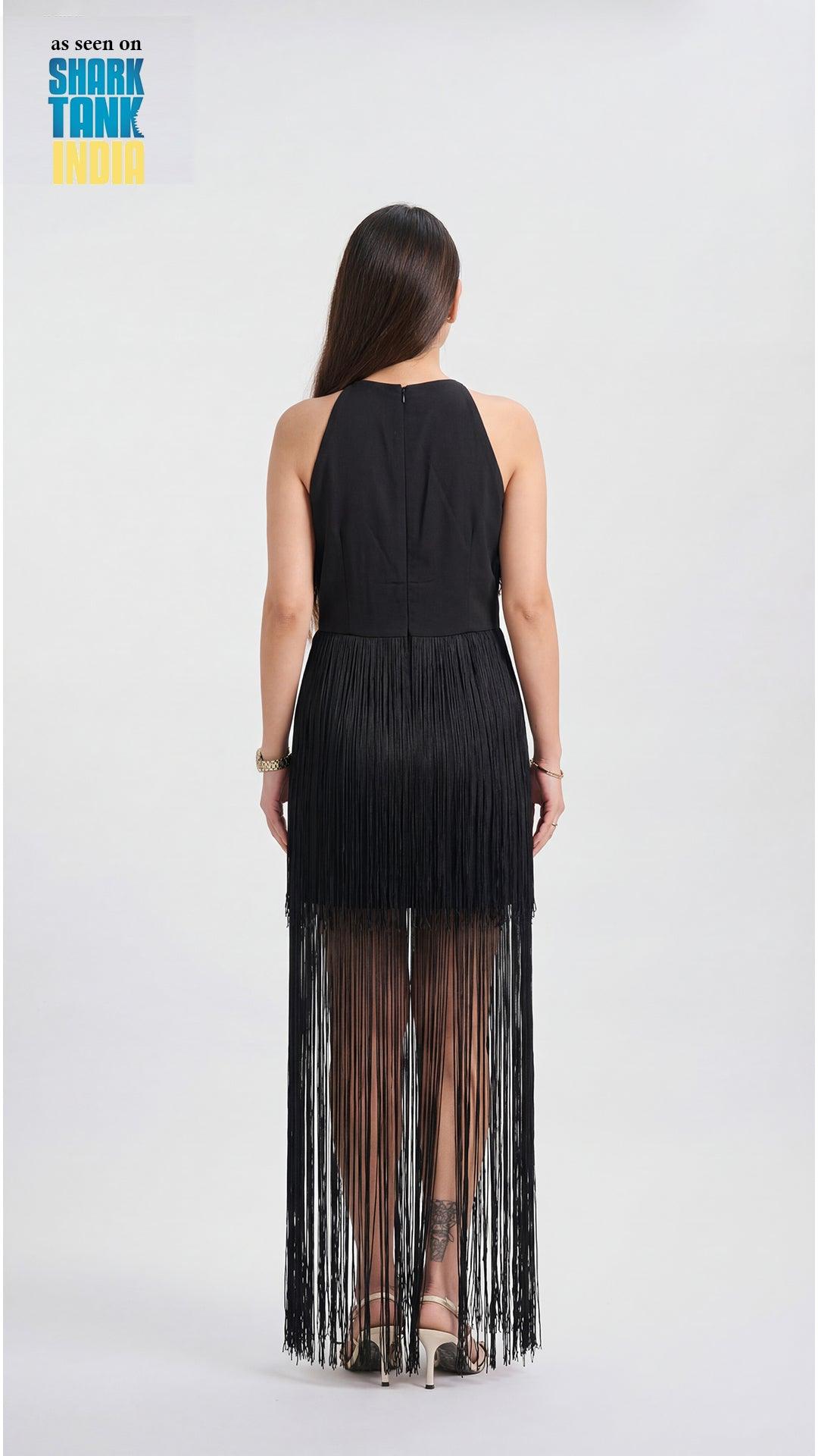 Woman wearing a black fringe dress on a white background with 'Shark Tank' branding.