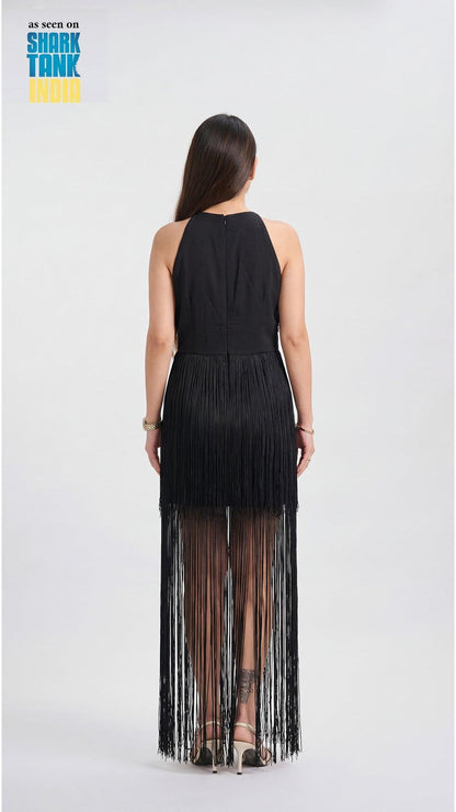 Woman wearing a black fringe dress on a white background with 'Shark Tank' branding.