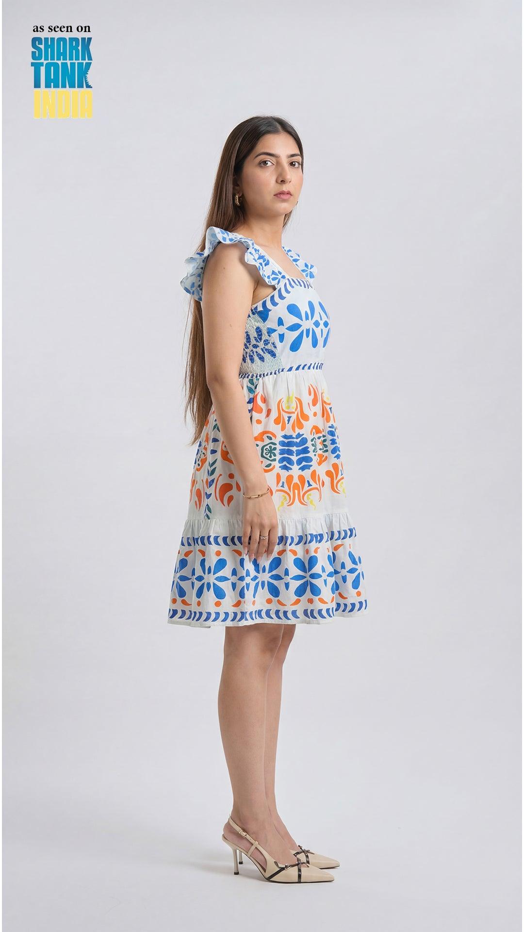 Woman wearing a colorful patterned dress on a white background