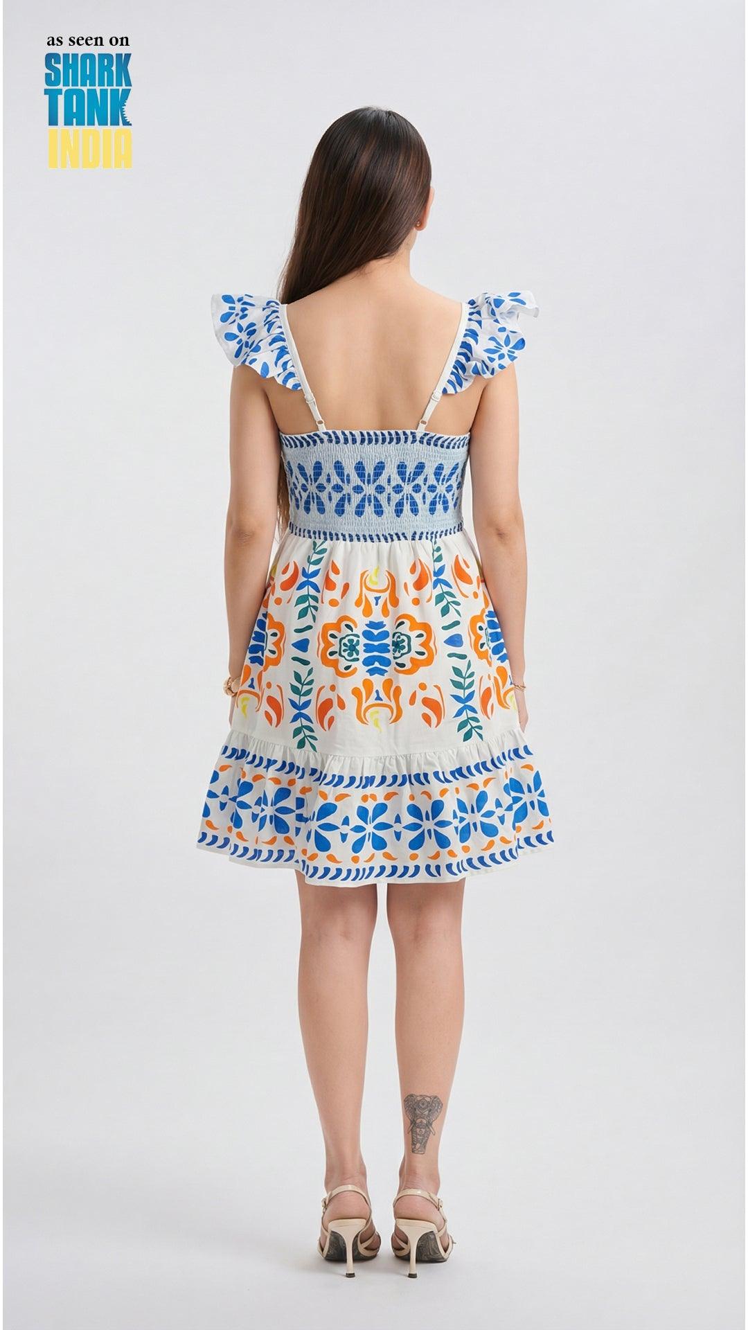Woman wearing a colorful dress with floral patterns on a white background