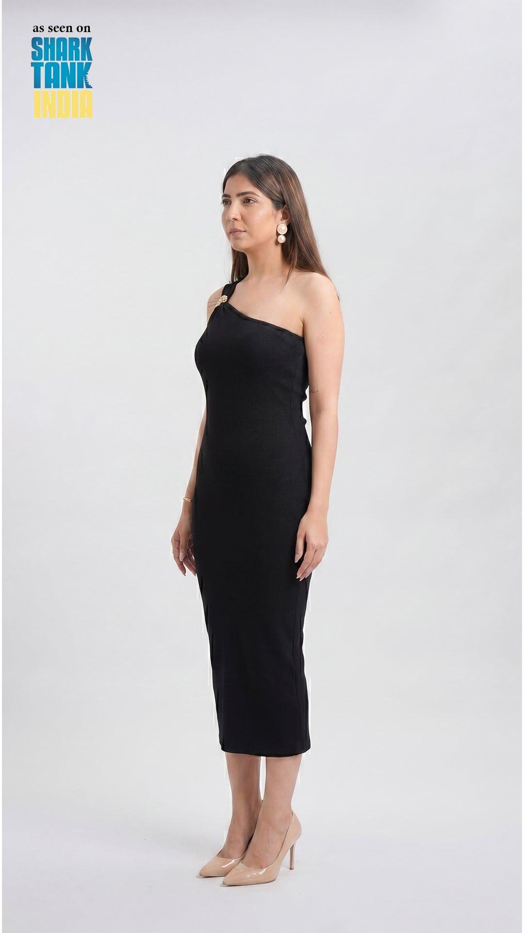 Woman wearing a black one-shoulder dress on a white background with 'Shark Tank' branding.