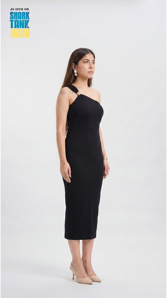 Woman wearing a black dress on a white background with 'Shark Tank' branding.