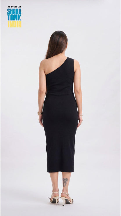 Woman wearing a black one-shoulder dress on a white background with 'Shark Tank' branding.
