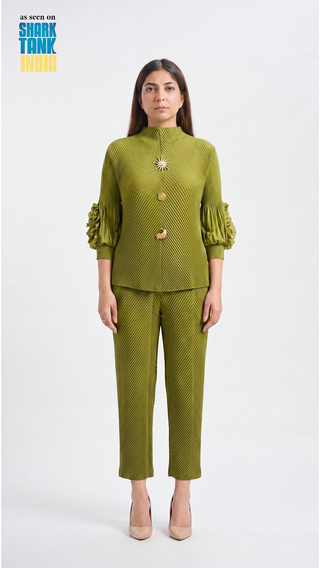 Woman wearing a green outfit with a brooch on a white background
