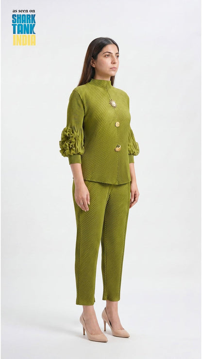 Woman wearing a green outfit with a textured pattern on a white background
