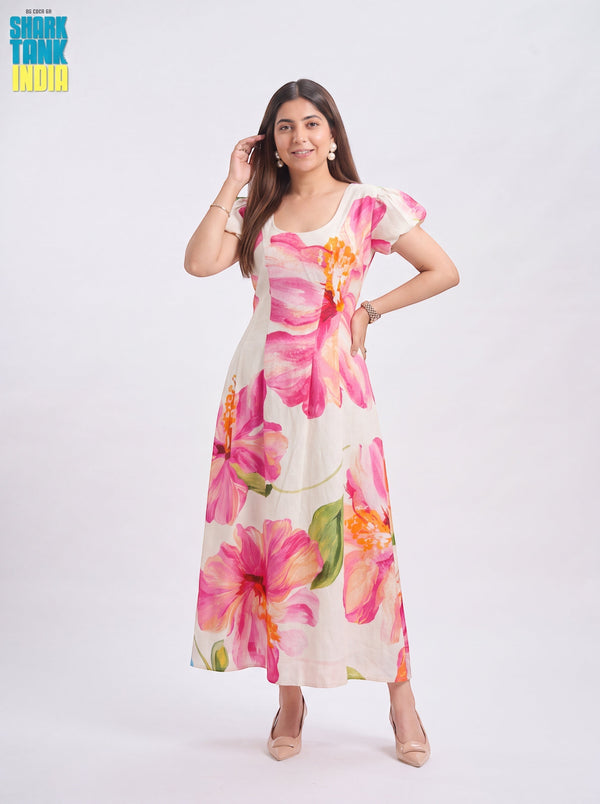 Model wearing TBFO ivory midi dress with oversized pink hibiscus floral print, square neckline, and puff sleeves.