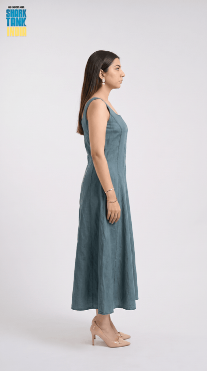 Woman wearing a teal dress on a white background