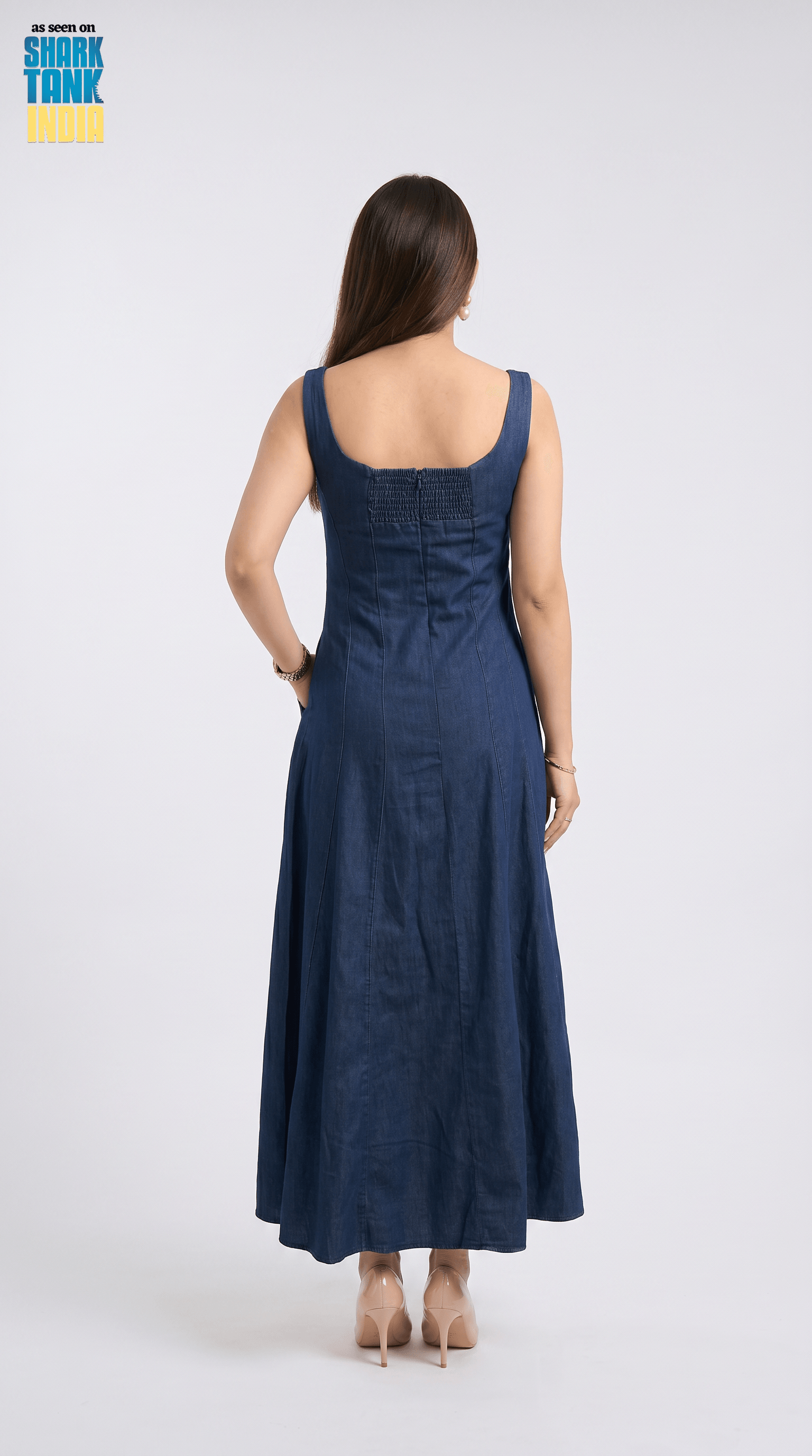 Woman wearing a blue dress against a white background