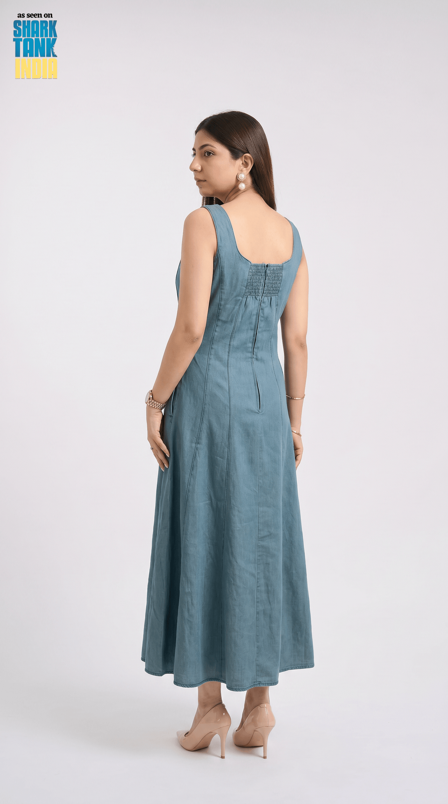 Woman wearing a blue dress on a white background