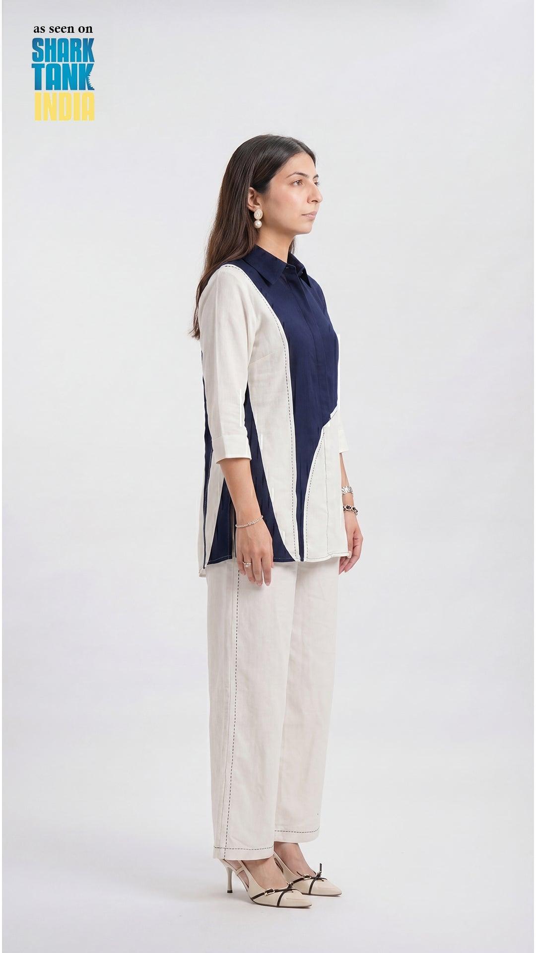Woman wearing a navy and white outfit on a white background