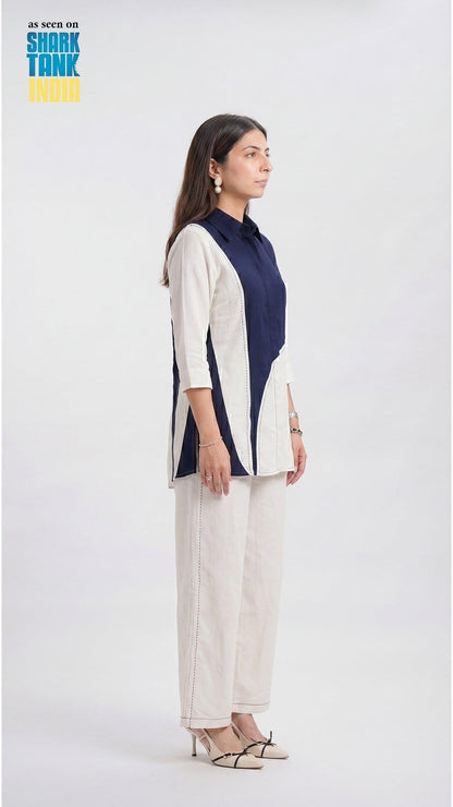 Woman wearing a navy and white outfit on a white background