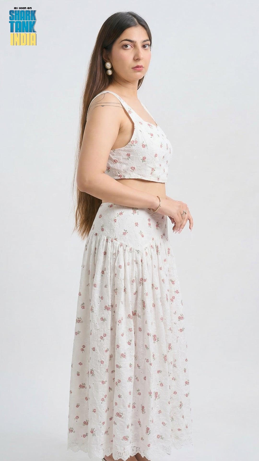 Woman wearing a white floral outfit on a white background