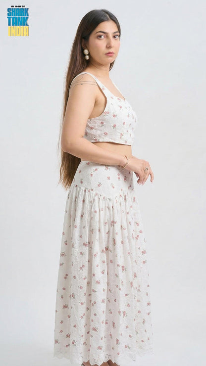 Woman wearing a white floral outfit on a white background