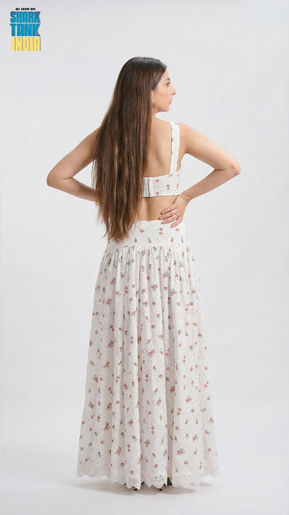 Woman wearing a white floral dress on a white background