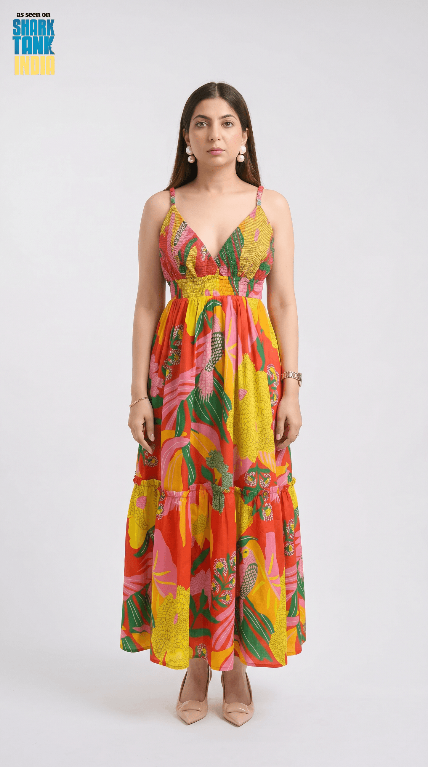 Woman wearing a colorful floral dress on a white background