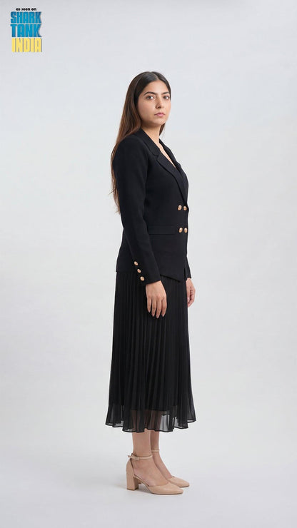 Woman wearing a black suit with gold buttons on a white background