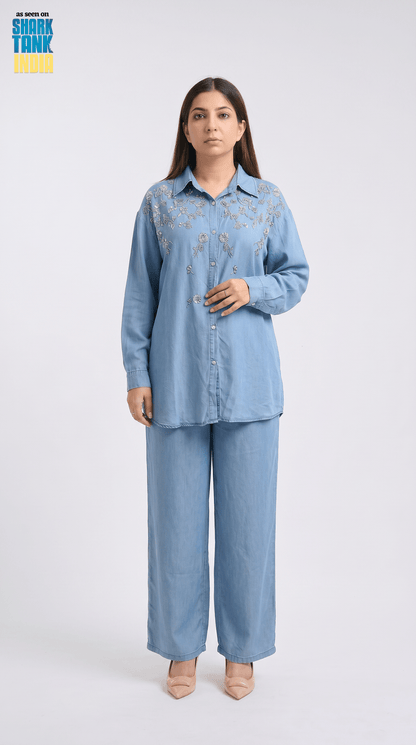 Woman wearing a light blue denim outfit on a white background