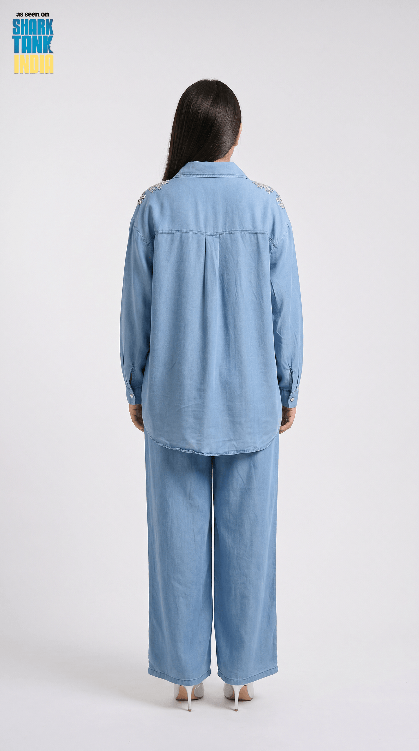 Person wearing a blue outfit on a white background