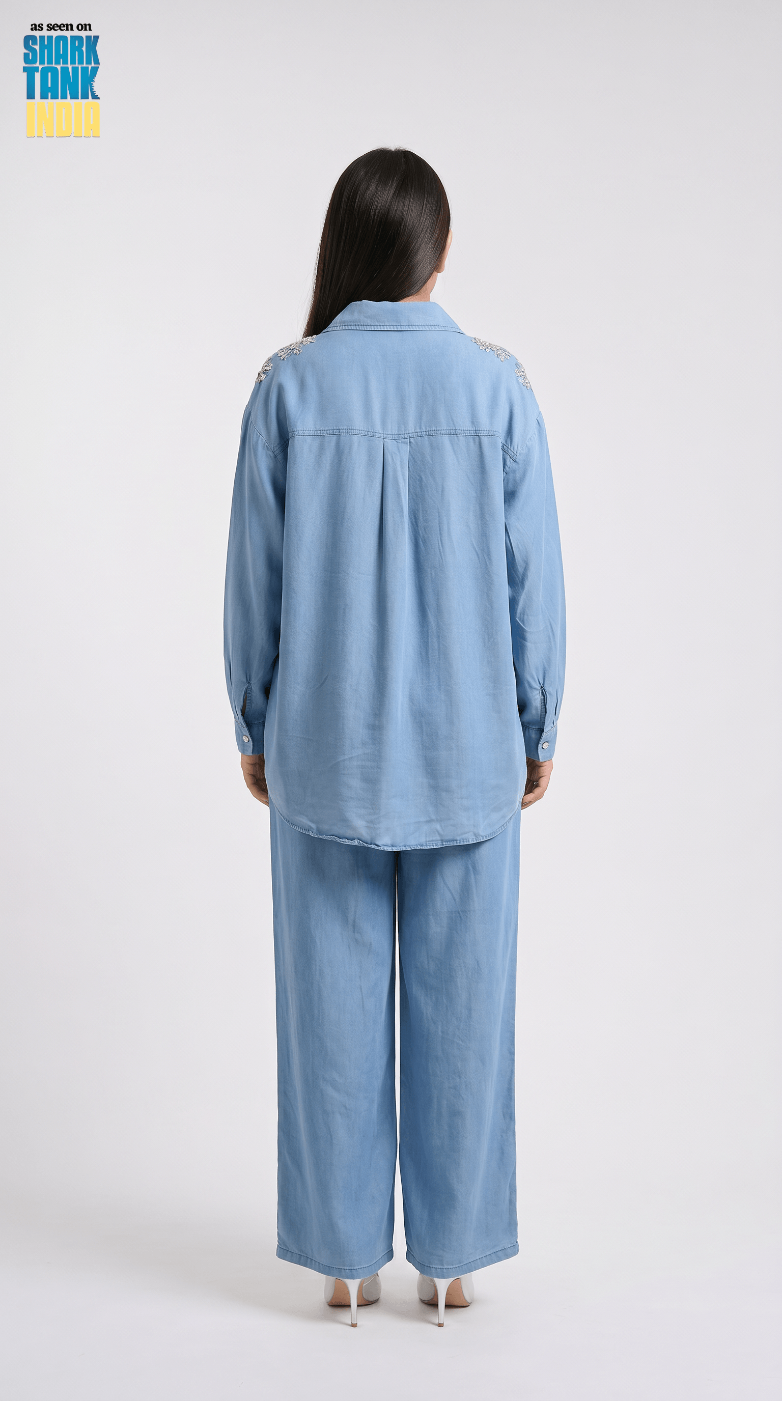 Person wearing a blue outfit on a white background