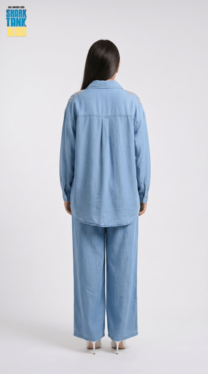 Person wearing a blue outfit on a white background
