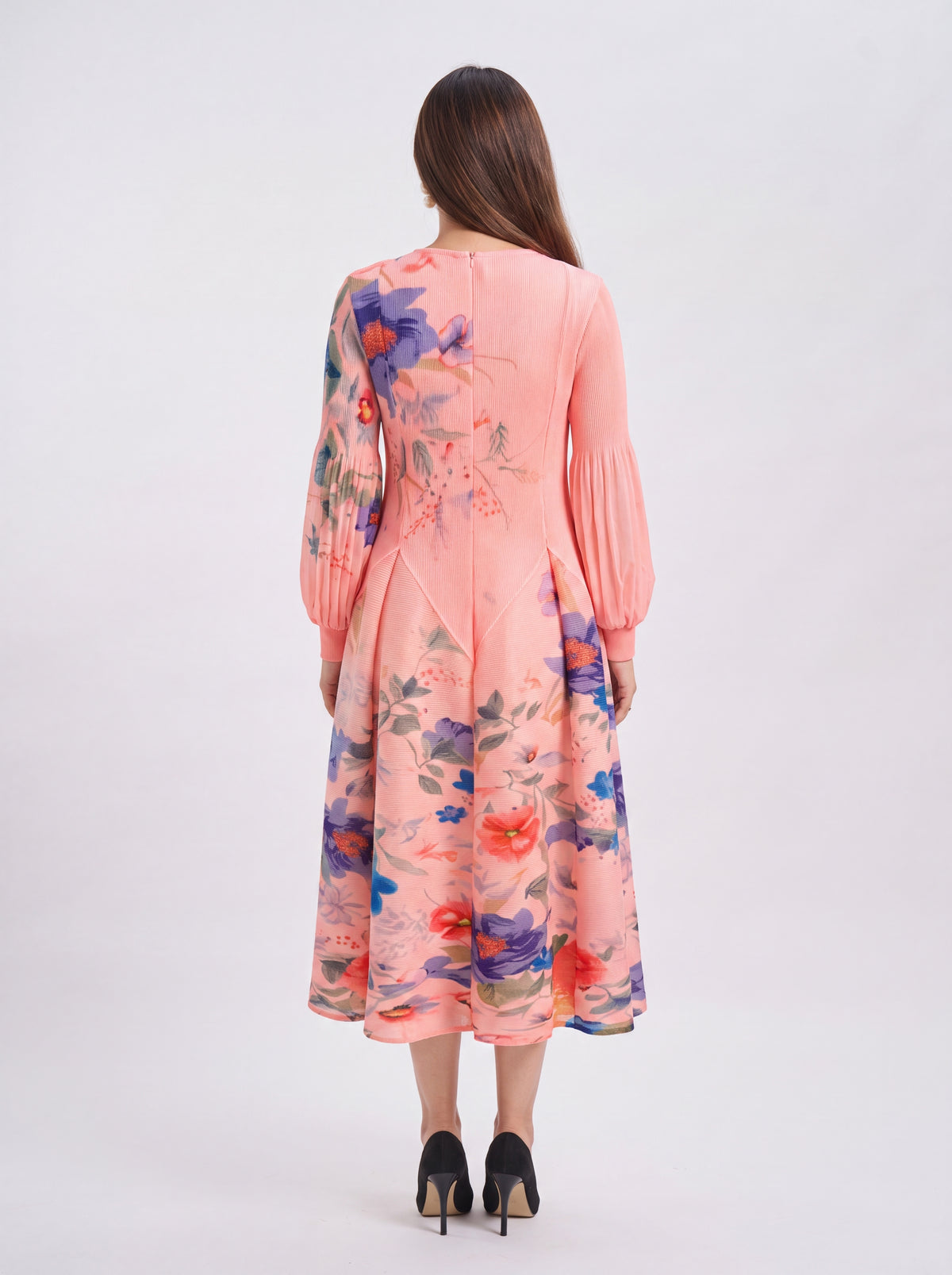 Woman wearing a pink floral dress on a white background