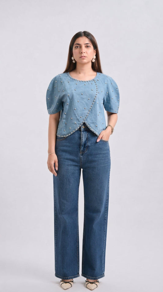 Woman wearing a blue denim top and jeans on a white background