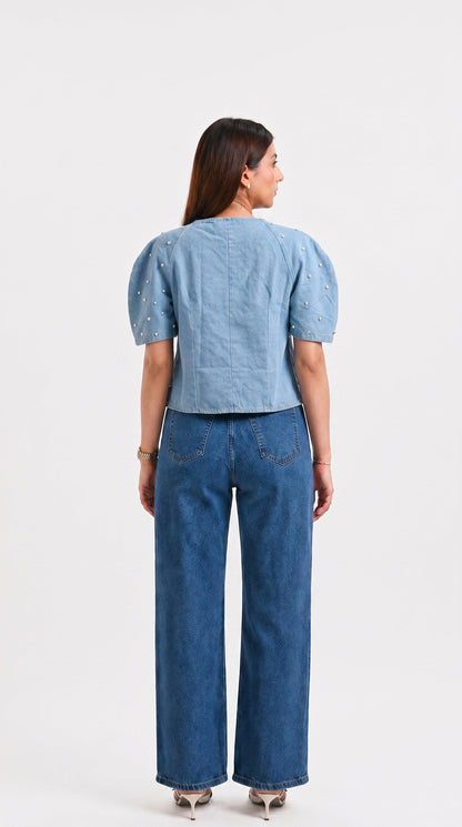Woman wearing a blue denim outfit on a white background