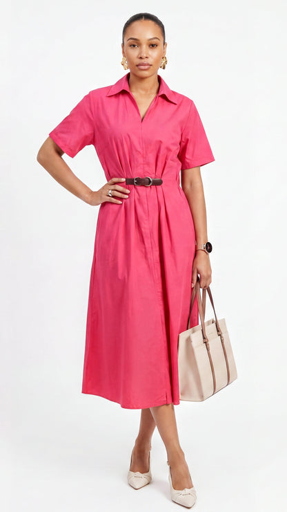 Woman wearing a pink dress holding a beige handbag on a white background