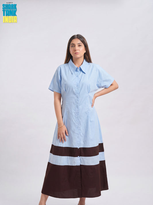 Woman wearing a light blue and brown dress on a white background