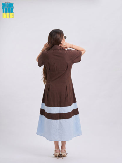 Woman wearing a brown and light blue dress with 'Snooki Tank India' branding.