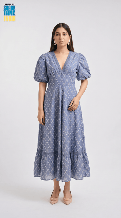 Woman wearing a blue patterned dress on a white background