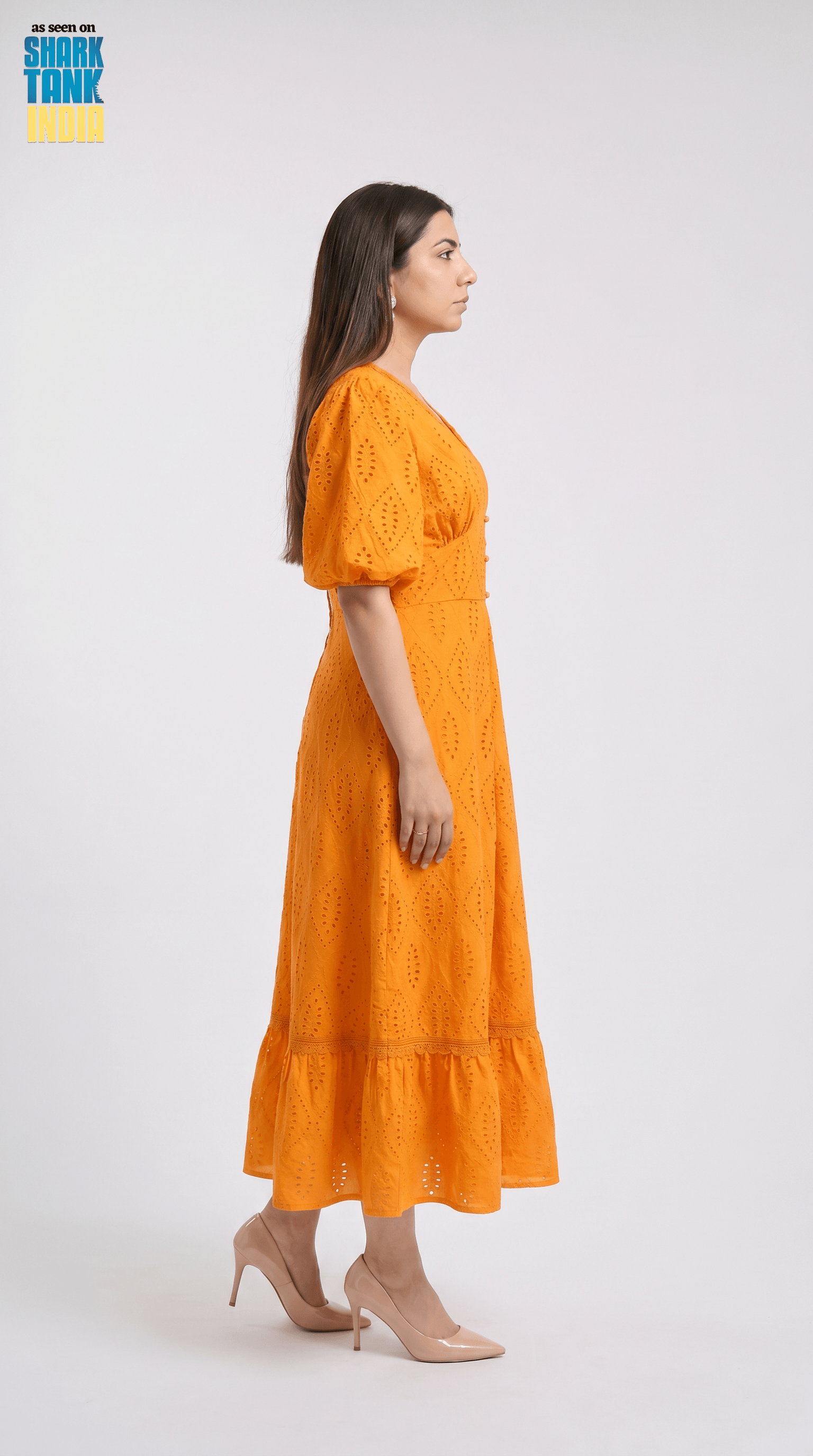 Woman wearing an orange dress on a white background