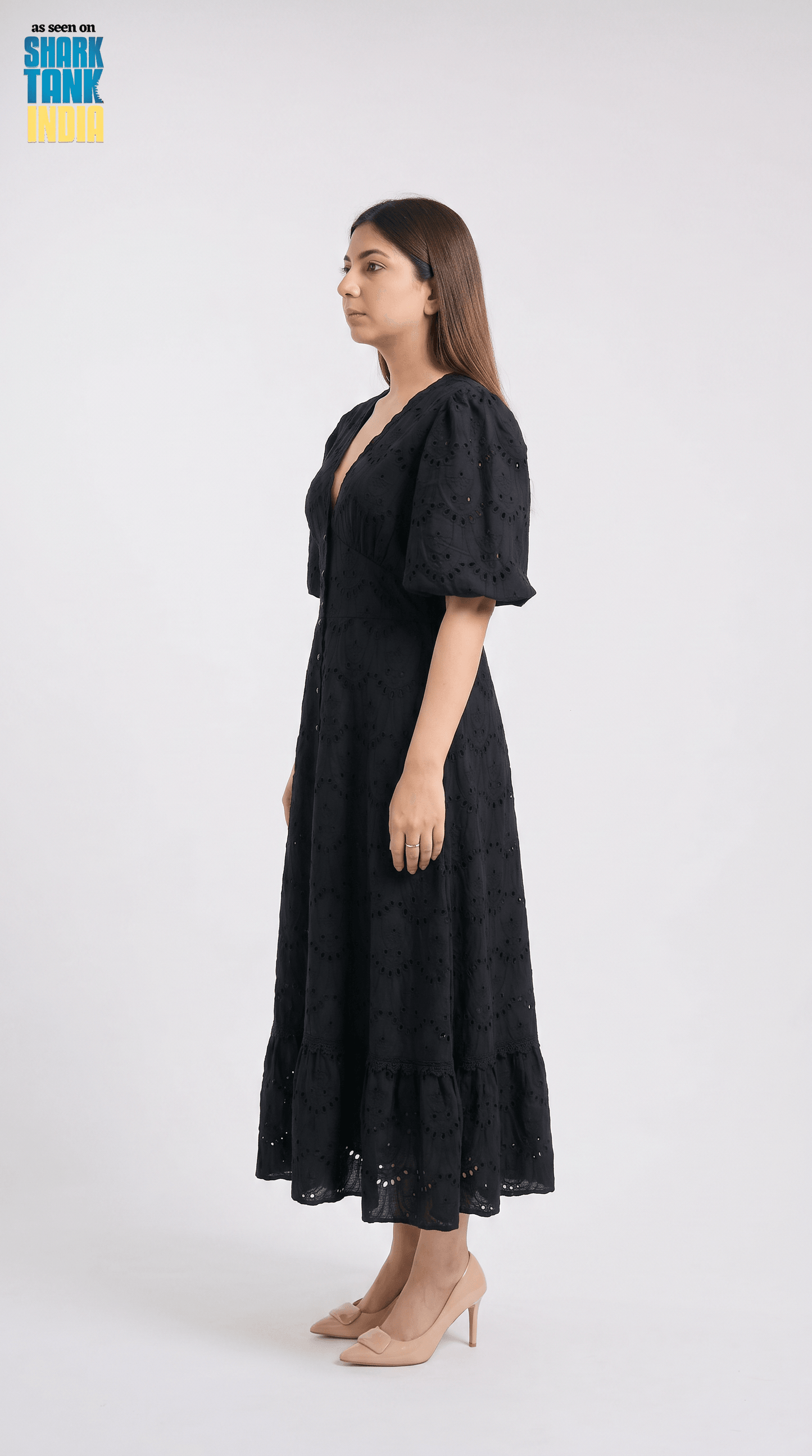Woman wearing a black dress on a white background