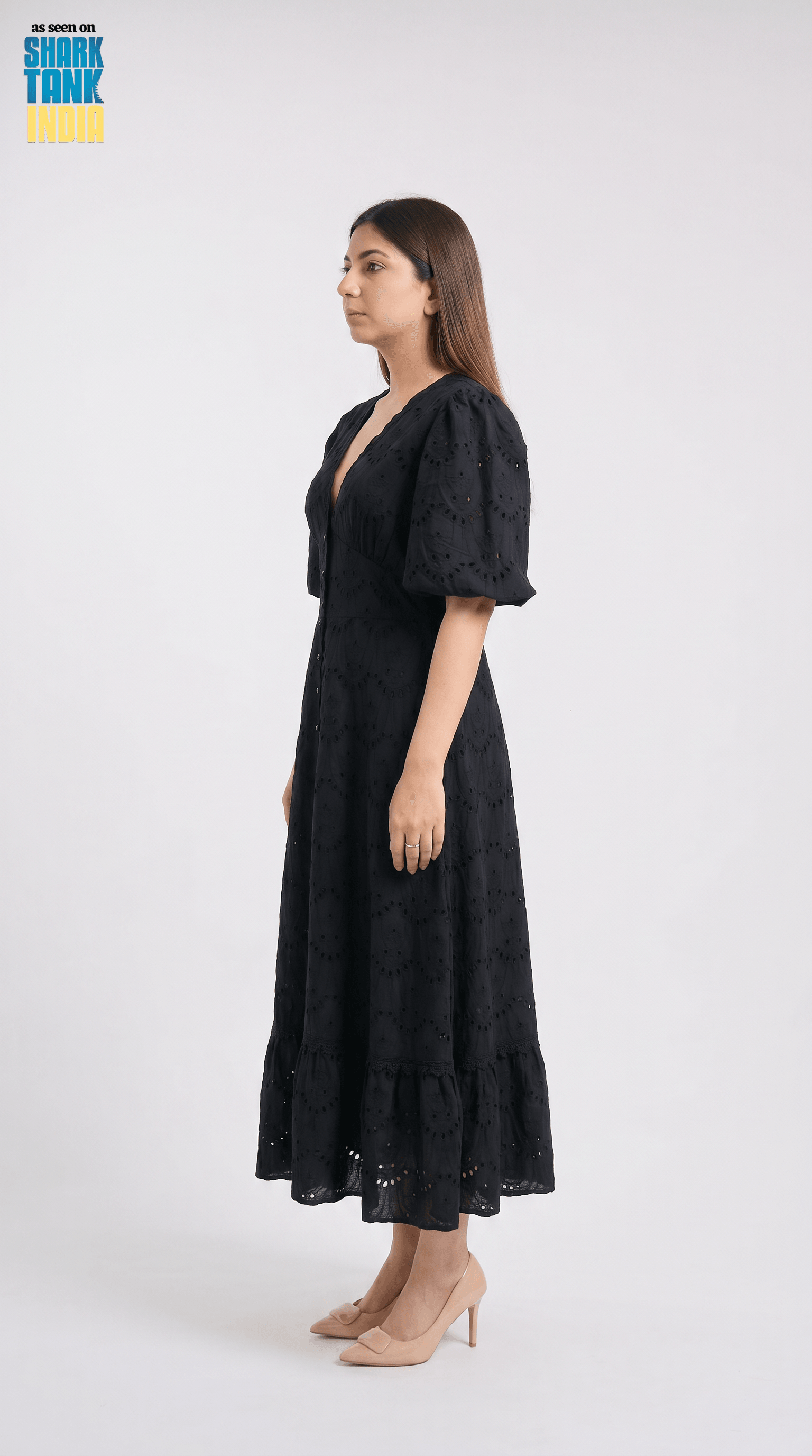 Woman wearing a black dress on a white background