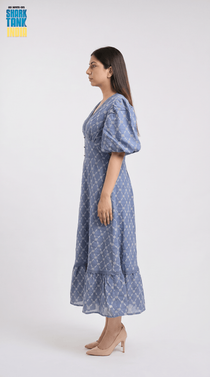 Woman wearing a blue patterned dress on a white background
