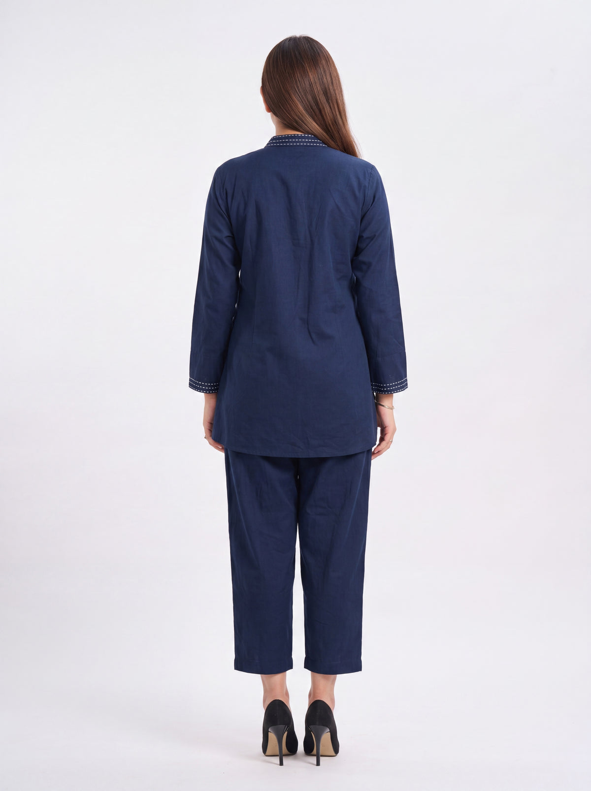 Woman wearing a navy blue suit on a white background