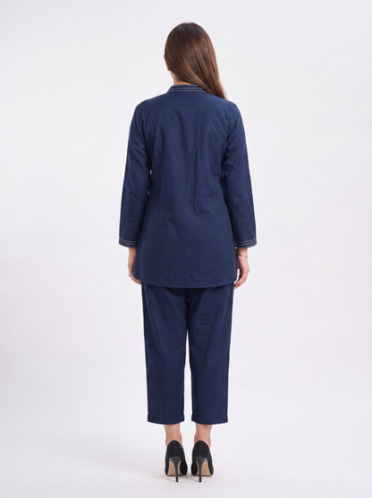 Woman wearing a navy blue suit on a white background