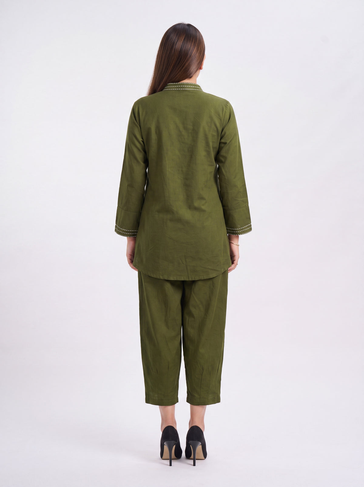 Woman wearing a green suit on a white background