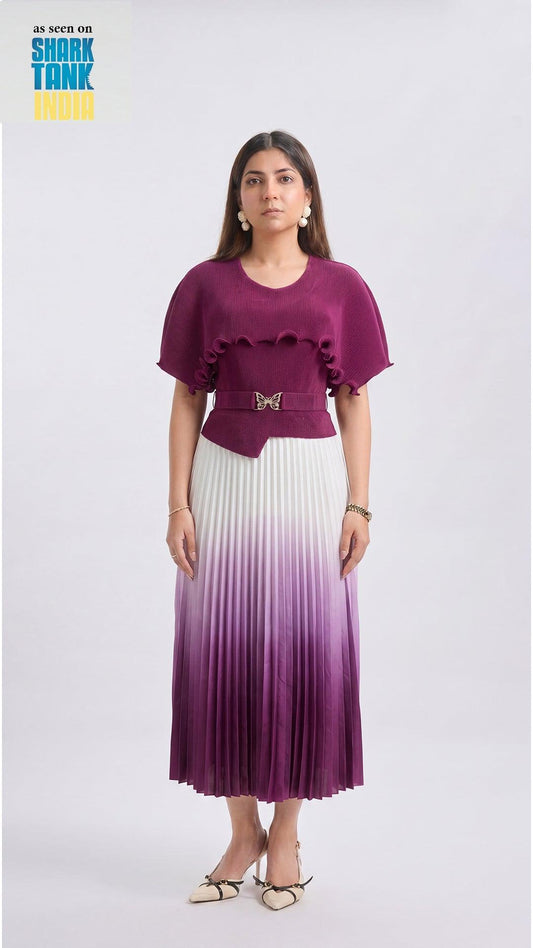 Woman wearing a purple top and gradient skirt on a white background