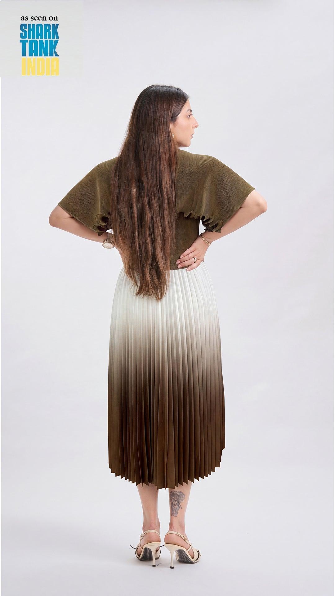 Woman wearing a green and white gradient dress on a plain background