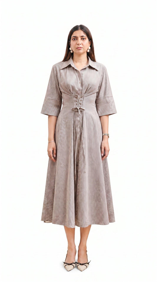 Woman wearing a beige dress with a belt on a white background