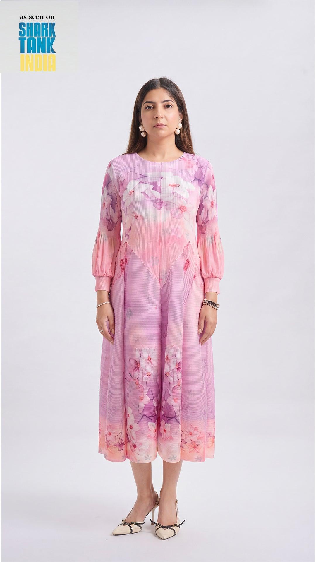 Woman wearing a pink and purple floral dress on a white background
