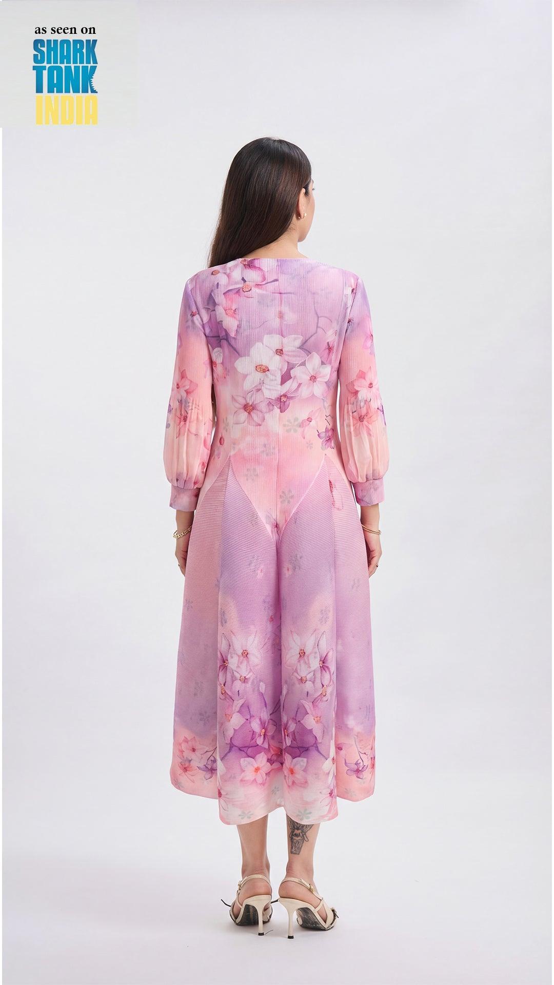 Woman wearing a pink floral dress with 'Shark Tank' branding on a white background