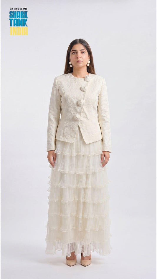 Woman wearing a cream-colored suit with a white background