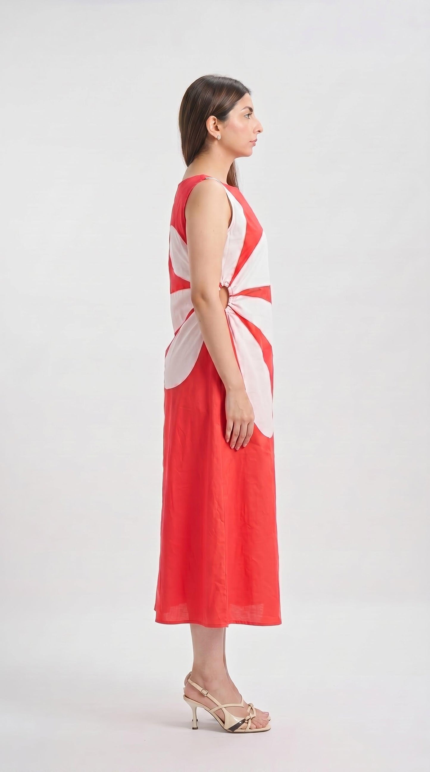 Woman wearing a red and white sleeveless dress on a white background